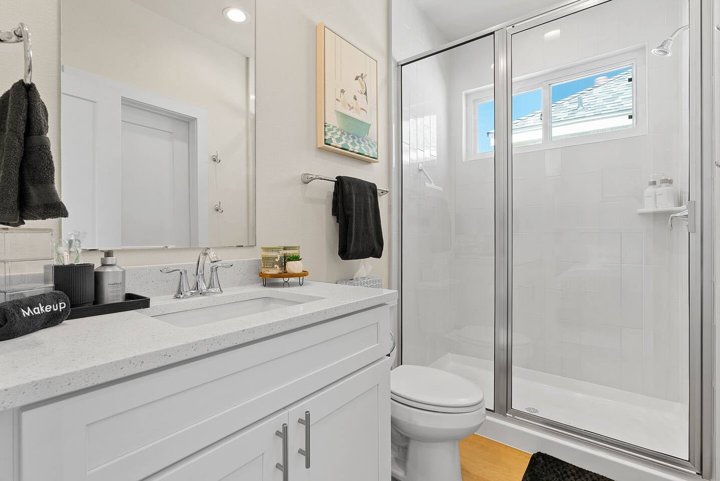 Master ensuite bathroom with spacious large shower, single vanity, and thoughtful amenities for your comfort. The walk-in closet is accessed from the bathroom.
