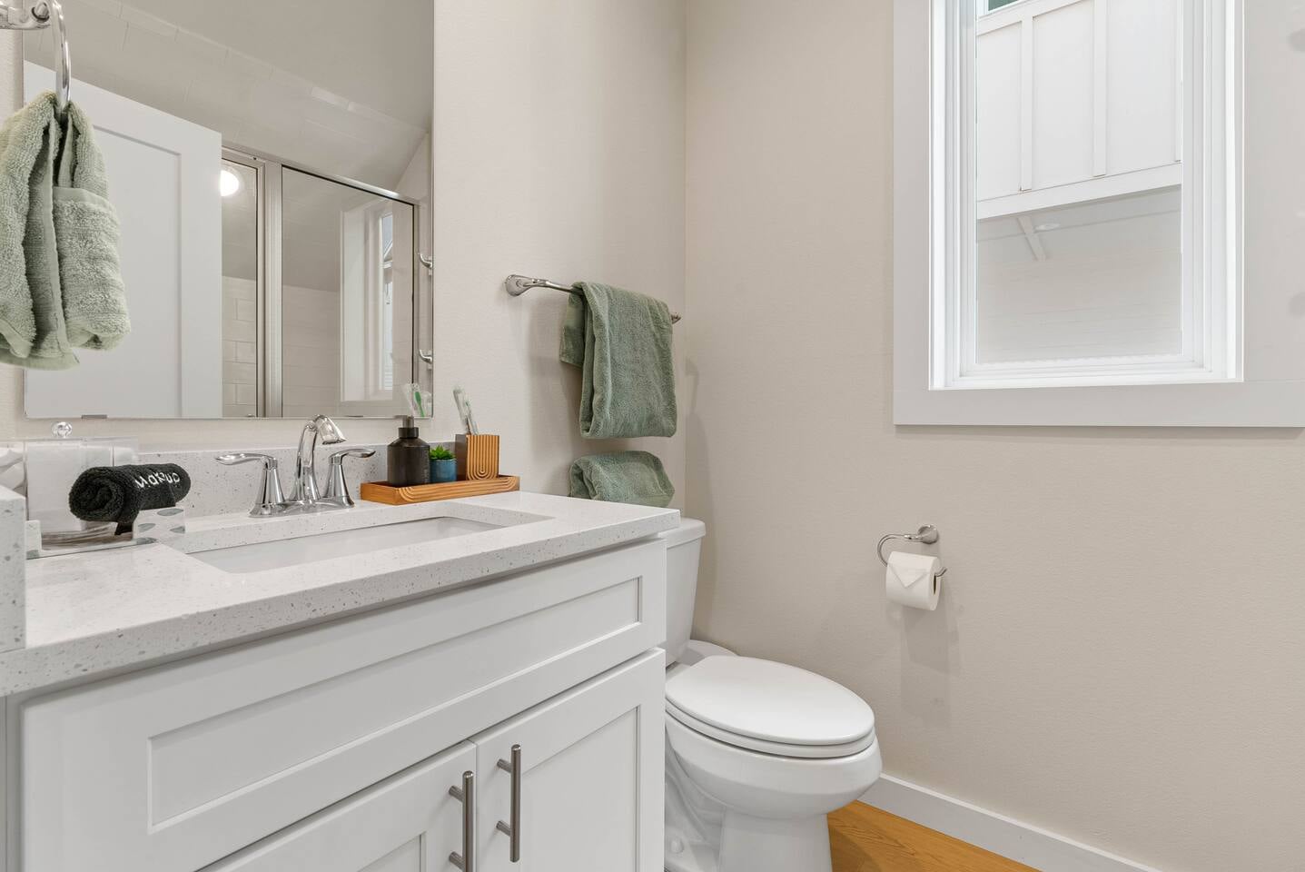 First-floor bathroom with shower conveniently located near guests in the downstairs bedroom or main entry level, stocked with essential amenities.