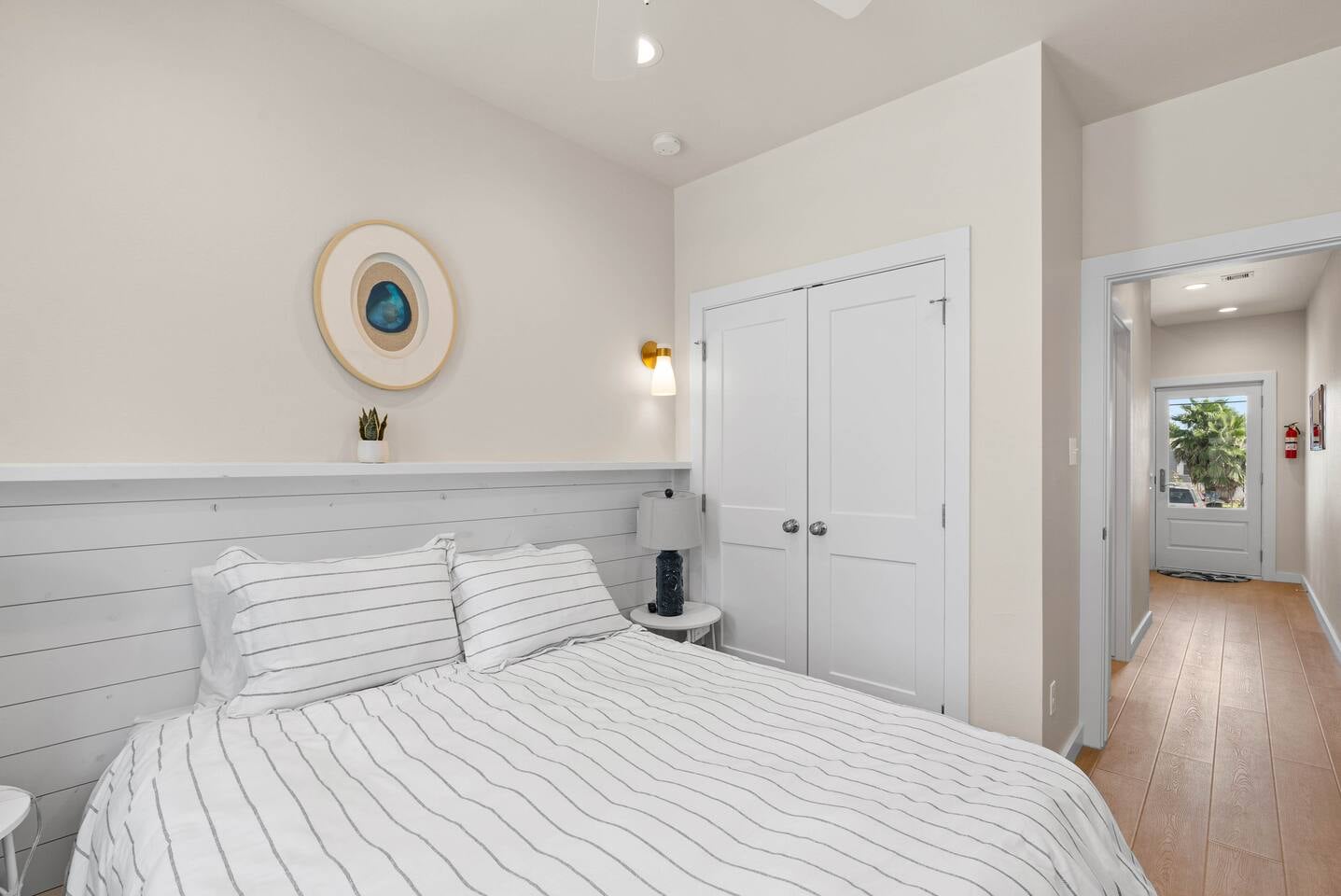 Another view of the first-floor bedroom with a view of the pool and convenient access to a bathroom just outside the door. Guests will love the added touch of a Keurig coffee maker tucked neatly in th
