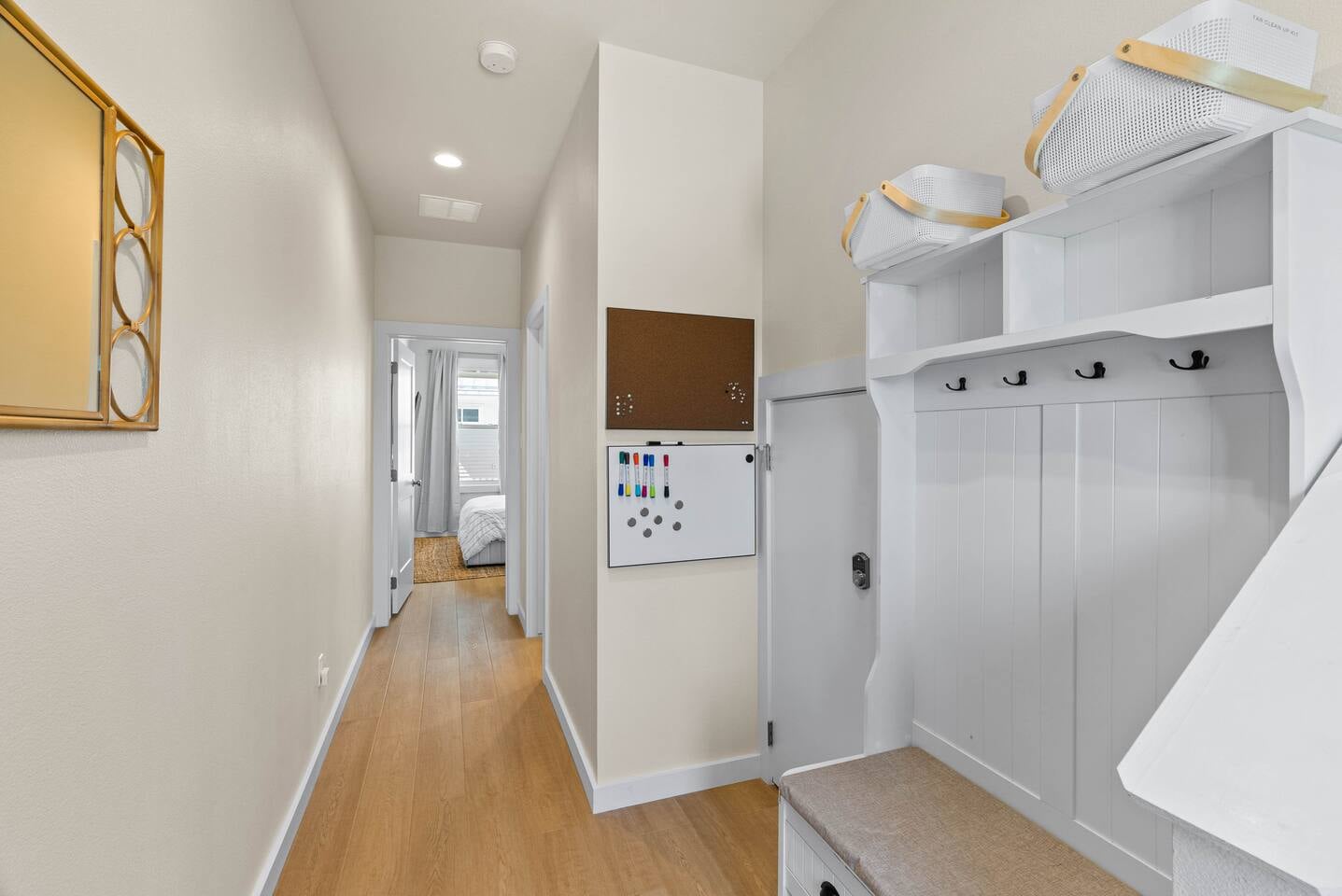 Entryway drop zone with hooks, baskets, and a family message board, perfect for organizing your beach gear during your stay.