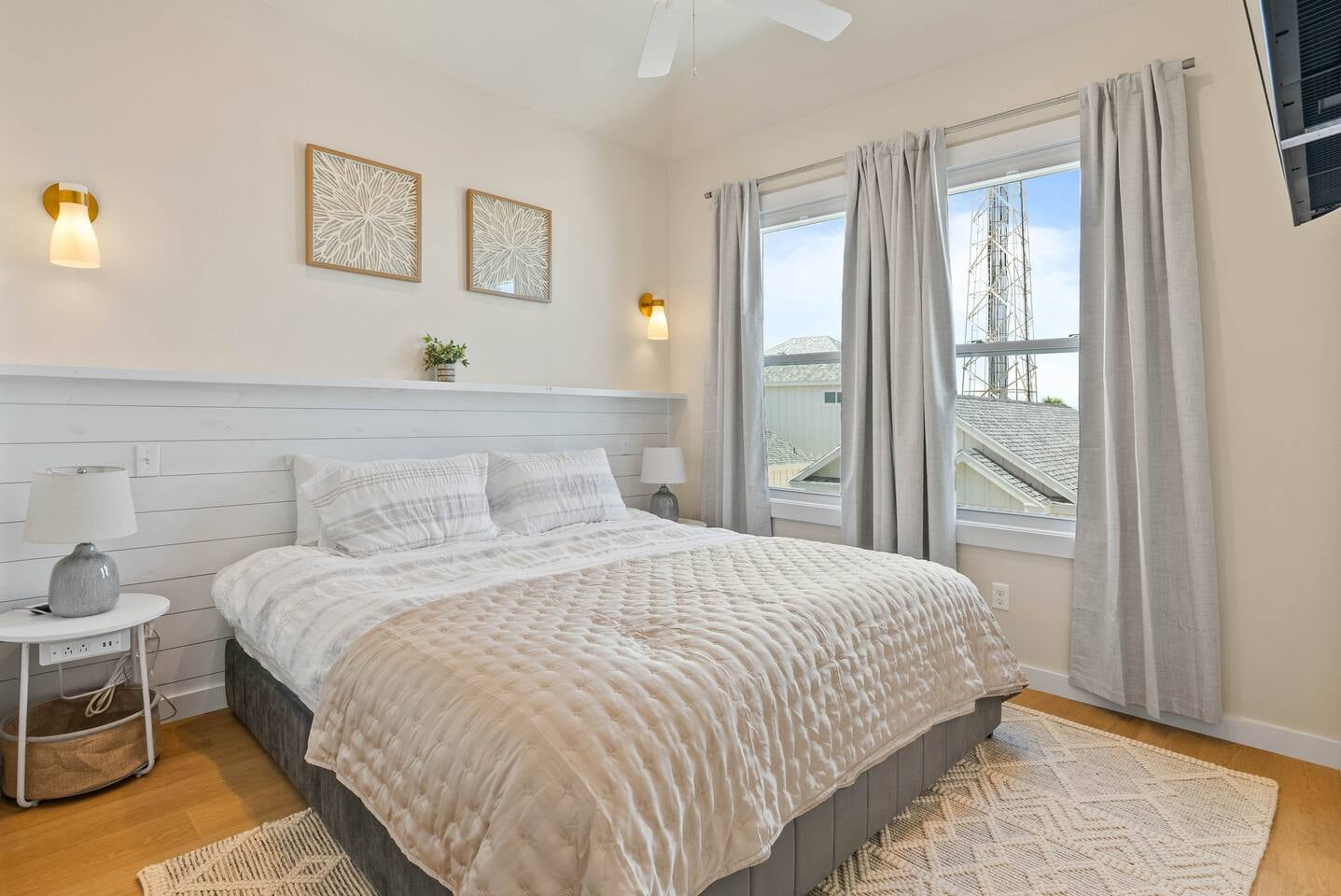 3rd-floor master bedroom with plush king bed, ensuite full bath with shower, large closet, and bright natural light, plus a view of the pool. Conveniently located electronic charging stations availab